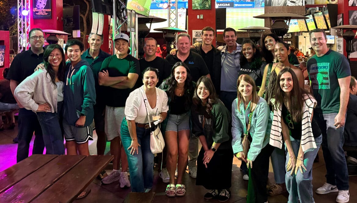 OPV parents taking a large group photo at a cocktail gathering